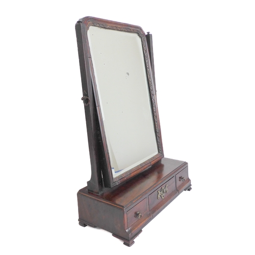 231A - An 18th century walnut toilet mirror: the parcel gilt frame around a hand-bevelled plate, three frie... 