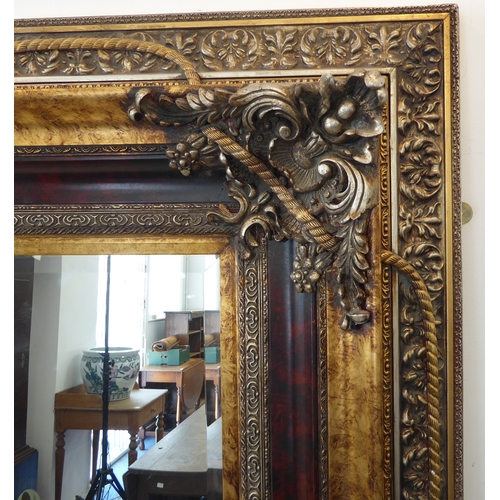 238 - A large and extremally elaborate gilt-framed wall-hanging looking glass in 19th century style (good ... 