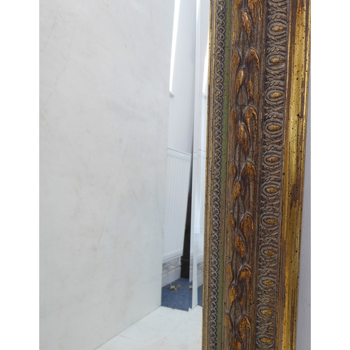 239A - A modern gilt-framed looking glass: the frame with moulded laurel-leaf-style decoration and hand-bev... 