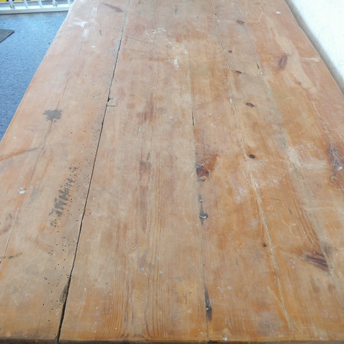 385A - A early 20th century pine farmhouse style kitchen table on square tapering legs (220cm wide x 77cm d... 