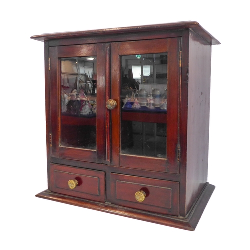 202A - A late 19th/early 20th century mahogany table cabinet: the moulded top above two glazed doors enclos... 