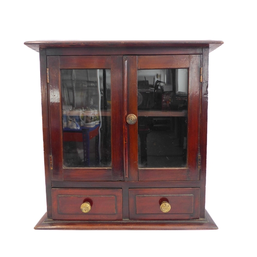 202A - A late 19th/early 20th century mahogany table cabinet: the moulded top above two glazed doors enclos... 