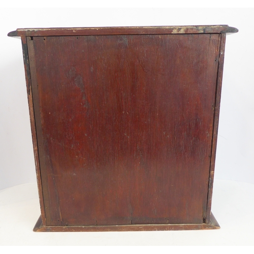 202A - A late 19th/early 20th century mahogany table cabinet: the moulded top above two glazed doors enclos... 