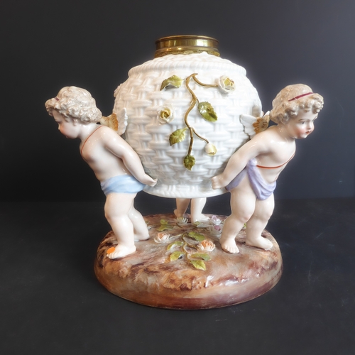 17 - A late 19th century hand-decorated continental porcelain lamp-base: modelled as three cherubs suppor... 