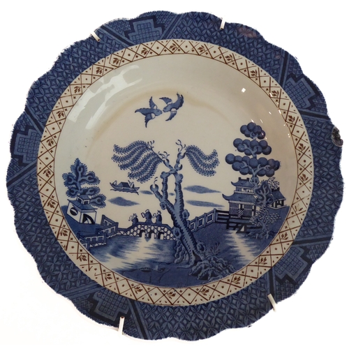 19 - A selection of blue-and-white 'Willow' pattern china to include a covered round dish (Gibson & Son),... 