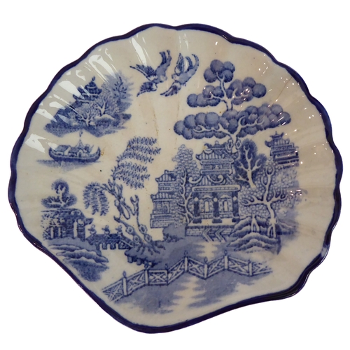 19 - A selection of blue-and-white 'Willow' pattern china to include a covered round dish (Gibson & Son),... 