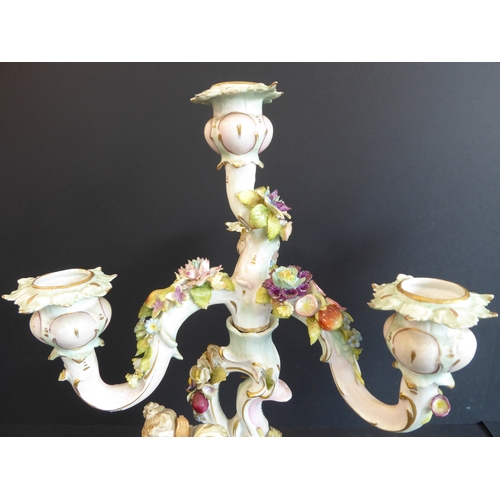 21 - A pair of late 19th century figural German porcelain four-light candelabra: meticulously applied flo... 