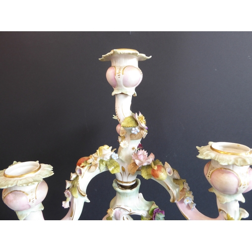 21 - A pair of late 19th century figural German porcelain four-light candelabra: meticulously applied flo... 