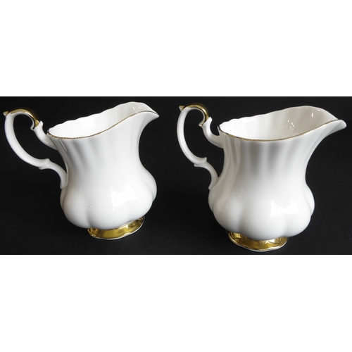 31 - A Royal Albert 'Val D'or' tea service comprising:
 2 teapots;
 2 milk jugs and 2 sugars;
 11 cups an... 