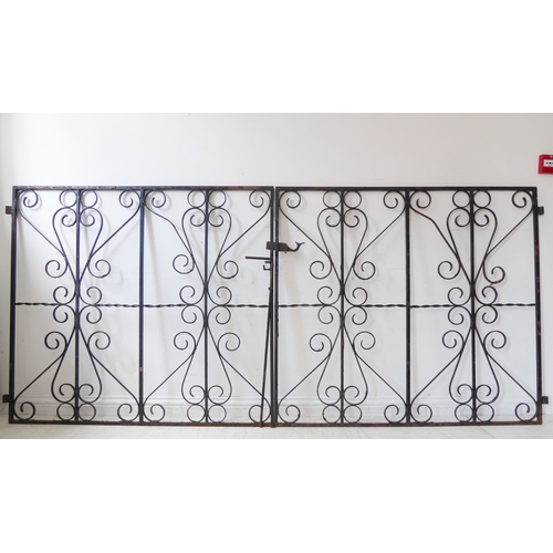 457 - A pair of wrought-iron gates with black-painted scrolling decoration (each gate 118 cm x 130 cm)