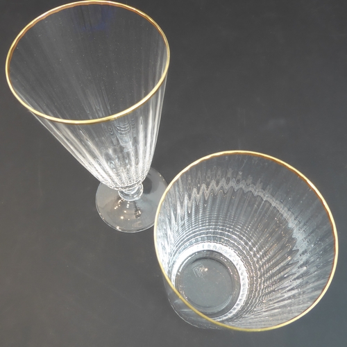 62 - A set of 11 Murano fluted water glasses with gilded rims (14 cm) and three matching wine glasses (15... 