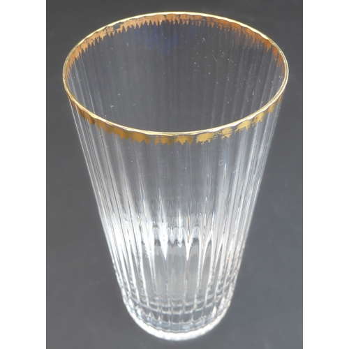 64 - A set of 23 Murano fluted water glasses with gilded rims (14 cm) and one similar but slightly larger... 