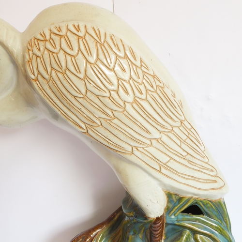 2 - A life-size ceramic model of a heron stepping through reeds: majolica glazes, probably mid-20th cent... 