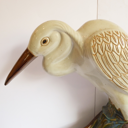 2 - A life-size ceramic model of a heron stepping through reeds: majolica glazes, probably mid-20th cent... 