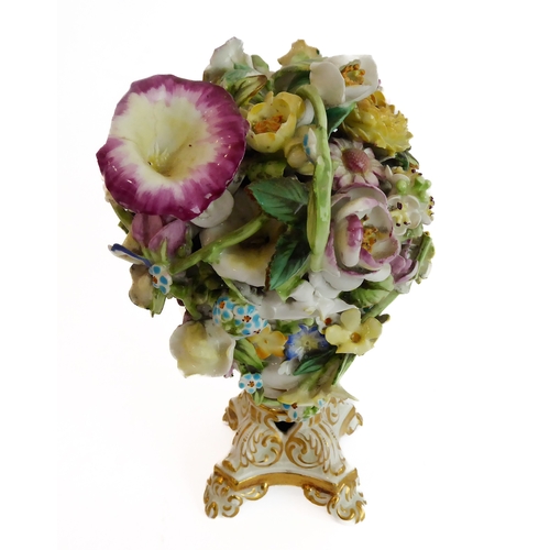 12 - A small ceramic group to include a late 19th century double vase by Moore modelled as flower encrust... 