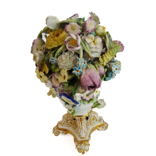 12 - A small ceramic group to include a late 19th century double vase by Moore modelled as flower encrust... 