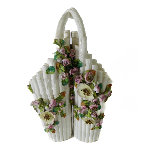 12 - A small ceramic group to include a late 19th century double vase by Moore modelled as flower encrust... 