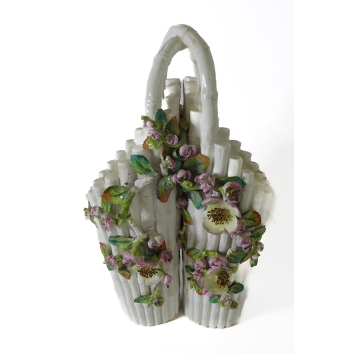 12 - A small ceramic group to include a late 19th century double vase by Moore modelled as flower encrust... 