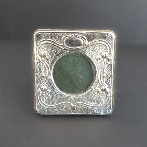 191 - A small sheet-silver-fronted photograph frame of Art Nouveau inspiration with a circular centre, mak... 