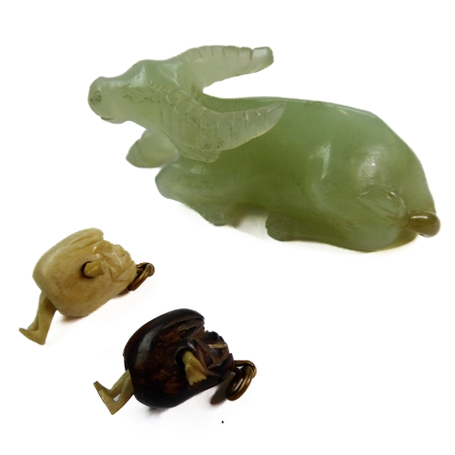 400 - A Qing Dynasty carved Chinese celadon jade model of a recumbent water buffalo (6.5cm), together with... 