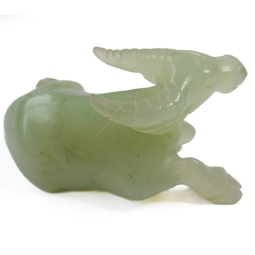 400 - A Qing Dynasty carved Chinese celadon jade model of a recumbent water buffalo (6.5cm), together with... 