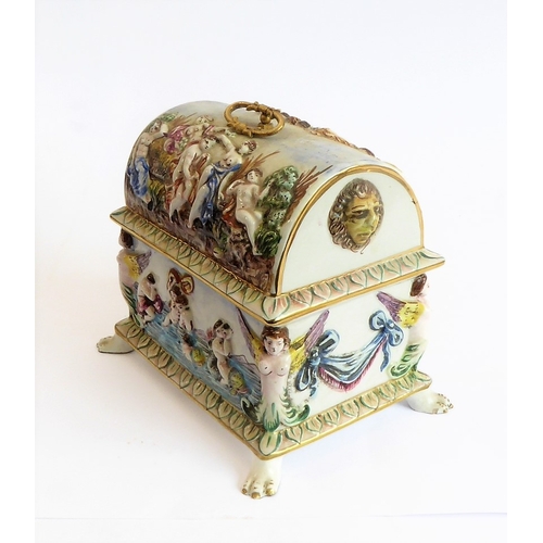 42 - A modern Capo di Monte porcelain dome-topped casket decorated in high relief with classical style fi... 