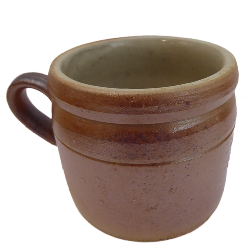 55 - Seven salt-glazed stoneware ale tankards each with ribbed strap handles, together with a Doulton Lam... 