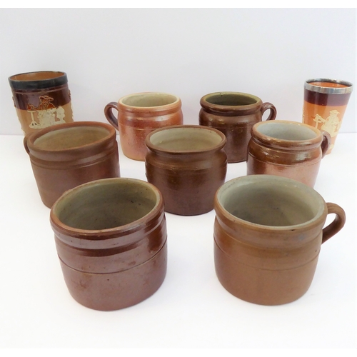 55 - Seven salt-glazed stoneware ale tankards each with ribbed strap handles, together with a Doulton Lam... 