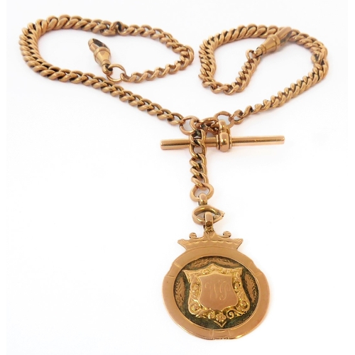 228 - A 9-carat yellow gold graduated curb link chain with two swivel terminals and suspending 9-carat yel... 