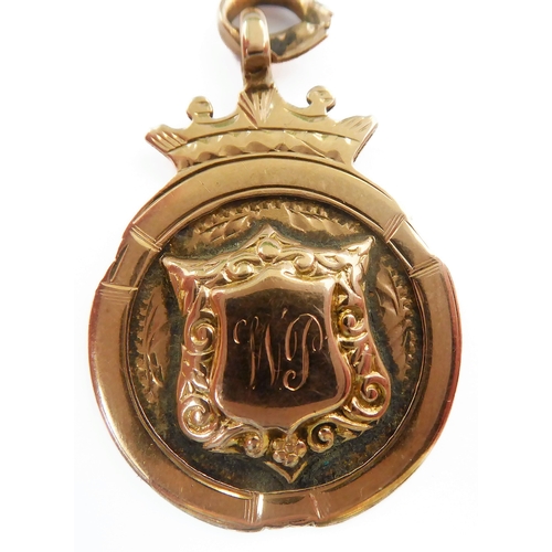 228 - A 9-carat yellow gold graduated curb link chain with two swivel terminals and suspending 9-carat yel... 