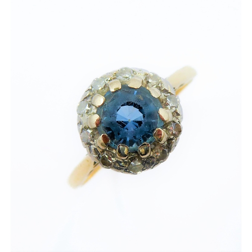 229 - A blue topaz/aquamarine and diamond-set cluster ring: the circular mixed-cut blue topaz/aquamarine (... 