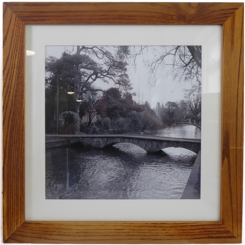 399 - A set of four wooden framed and glazed black & white photographs relating to Bourton-on-the-Water in... 