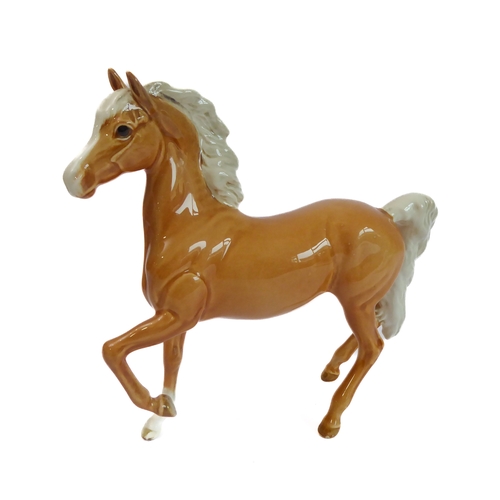 36 - Eleven pieces by Beswick:
 huntsman on a rearing horse (868);
 three foxhounds (one boxed), 
 palomi... 