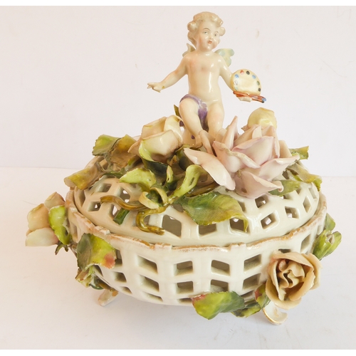14 - A group of five comprising:
 a Capo di Monte style circular potpourri surmounted with a cherub with ... 