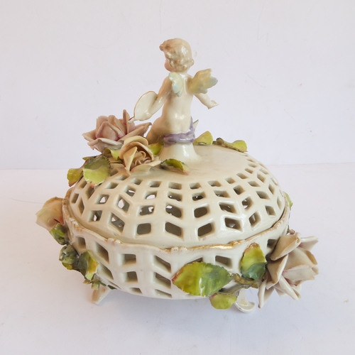 14 - A group of five comprising:
 a Capo di Monte style circular potpourri surmounted with a cherub with ... 