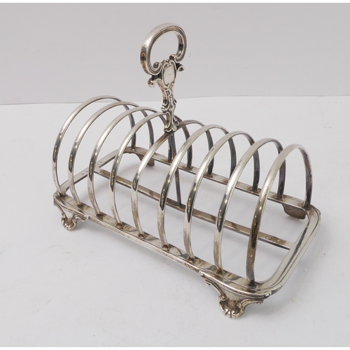 207 - A large early Victorian hallmarked silver eight-division toast-rack: the cast scrolling handle with ... 