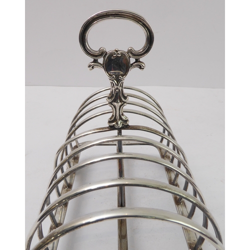 207 - A large early Victorian hallmarked silver eight-division toast-rack: the cast scrolling handle with ... 