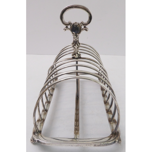 207 - A large early Victorian hallmarked silver eight-division toast-rack: the cast scrolling handle with ... 