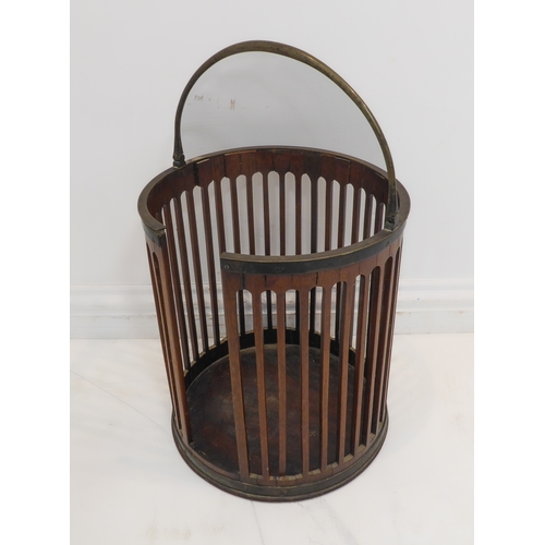 395 - A George III period circular pierced mahogany plate bucket with original swing-handle (32.5cm diamet... 