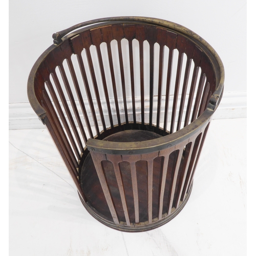 395 - A George III period circular pierced mahogany plate bucket with original swing-handle (32.5cm diamet... 