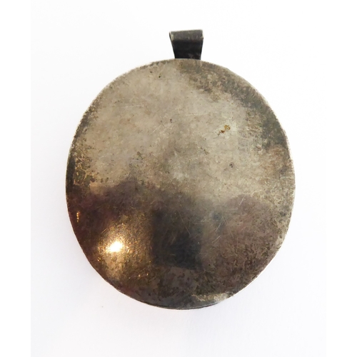356 - A fascinating collection of seven mostly white metal and glazed religious pendant reliquaries relati... 
