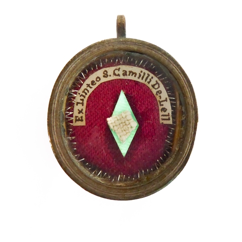356 - A fascinating collection of seven mostly white metal and glazed religious pendant reliquaries relati... 