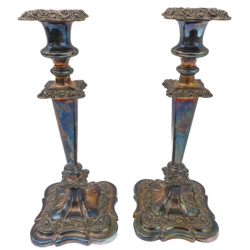 121 - A pair of large silver-plate on copper candlesticks. (One broken where the stem meets the base, and ... 