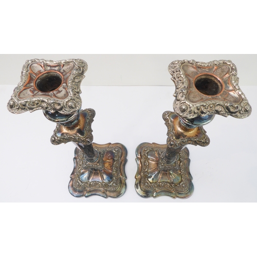 121 - A pair of large silver-plate on copper candlesticks. (One broken where the stem meets the base, and ... 