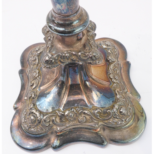 121 - A pair of large silver-plate on copper candlesticks. (One broken where the stem meets the base, and ... 