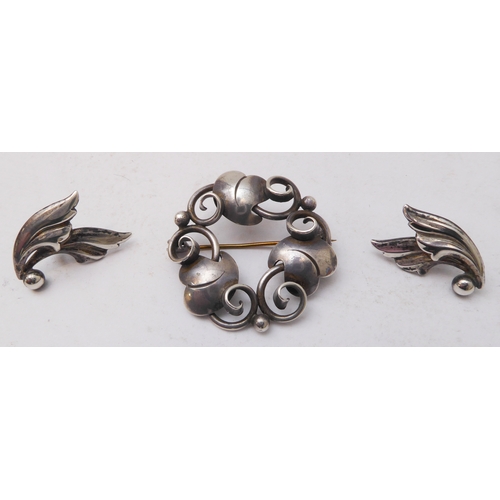 129 - A Georg Jensen design silver-coloured brooch, together with a small pair of Jensen silver leaf-desig... 