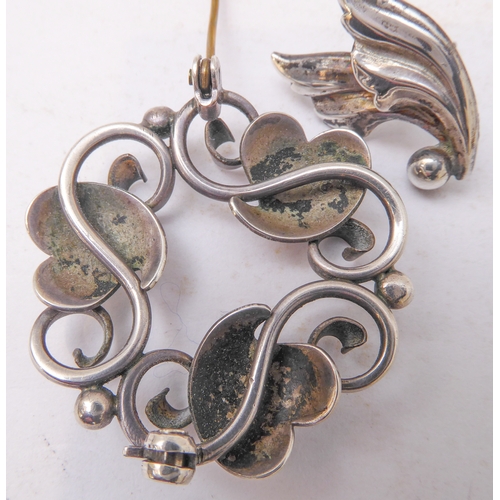 129 - A Georg Jensen design silver-coloured brooch, together with a small pair of Jensen silver leaf-desig... 