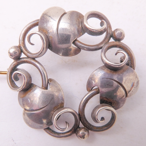 129 - A Georg Jensen design silver-coloured brooch, together with a small pair of Jensen silver leaf-desig... 