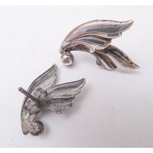 129 - A Georg Jensen design silver-coloured brooch, together with a small pair of Jensen silver leaf-desig... 