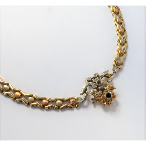 165 - a 14-carat yellow gold (marked '585', Italy) openwork neck chain with an integral flowerhead style p... 